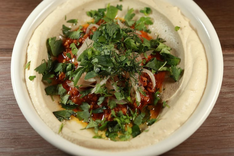 Persian lamb hummus at Dizengoff, one day with pickles, another stewed with orange and pistachios, hits with an aromatic Persian spice. (DAVID M WARREN / Staff Photographer)