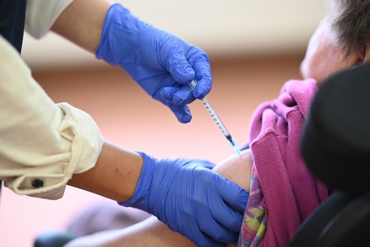 Medical student Mara Karcher vaccinates a resident of Sankt Verena nursing home in Straßberg, Germany, Wednesday, Dec. 30, 2020.