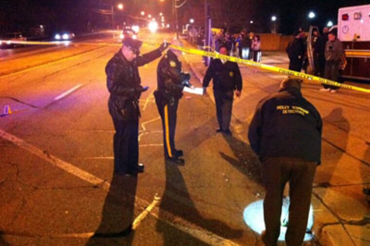 Ridley Township police investigate the scene at Morton Avenue and MacDade Boulevard where four teens were struck by a van allegedly running a red light. (Bob Moran / Staff)