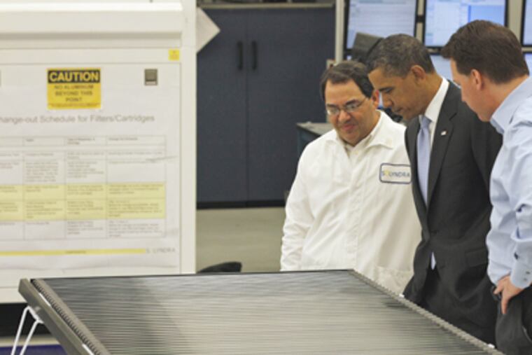 President Obama got a tour of Solyndra last year from executive vice president Ben Bierman (left) and founder Chris Gronet. (Alex Brandon / Associated Press, File)