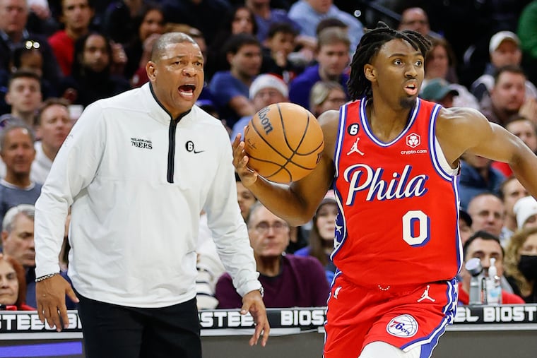 Sixers guard Tyrese Maxey dribbles the basketball with Head Coach Doc Rivers yelling instructions against the Chicago Bulls on Friday, January 6, 2023 in Philadelphia.
