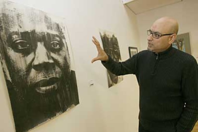 Antonio Puri, organizer of the Art4Barter show, in its current venue in Haddon Heights. The West Chester-based artist says the barter system helps to connect artists with art lovers. (Charles Fox / Staff Photographer)