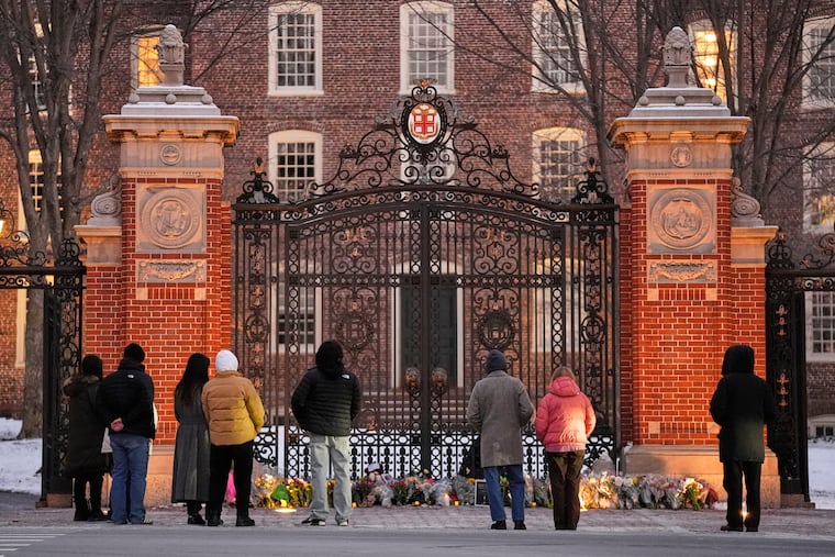 Visitors at a makeshift memorial for the victims of the Dec. 13 mass shooting at Brown University in Providence, R.I., in which two students, Ella Cook and Mukhammad Aziz Umurzokov, were killed. Umurzokov was an Uzbek immigrant.