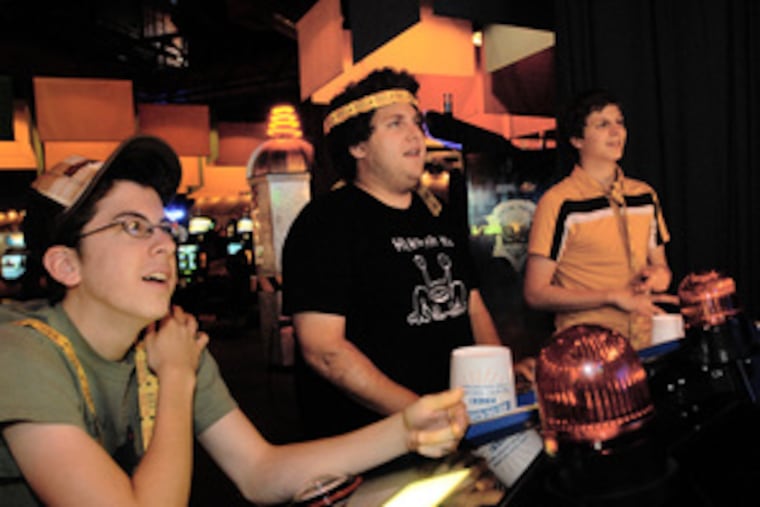 "Superbad" stars (from left) Christopher Mintz-Plasse, Jonah Hill and Michael Cera play a video game at Dave & Busters. Before the teen comedy even opens, they are being recognized.