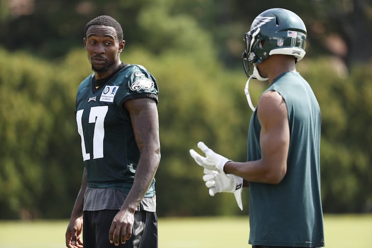 Eagles’ Alshon Jeffery, left, talks with Jordan Matthews, right, during Eagles training camp on Wednesday.