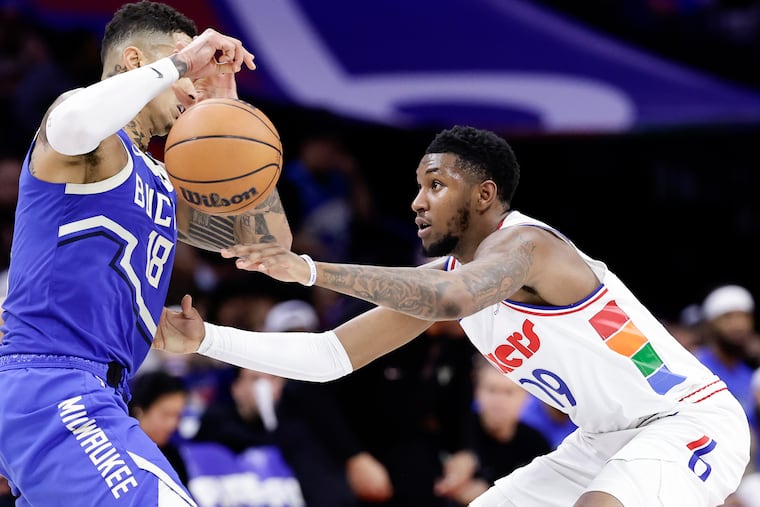 Sixers rookie Justin Edwards (right) stealing the ball from Bucks forward Kyle Kuzma on April 3.