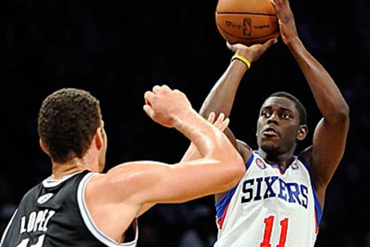 Jrue Holiday scored 11 points in the Sixers' 106-96 win over the Nets on Friday. (Kathy Kmonicek/AP)