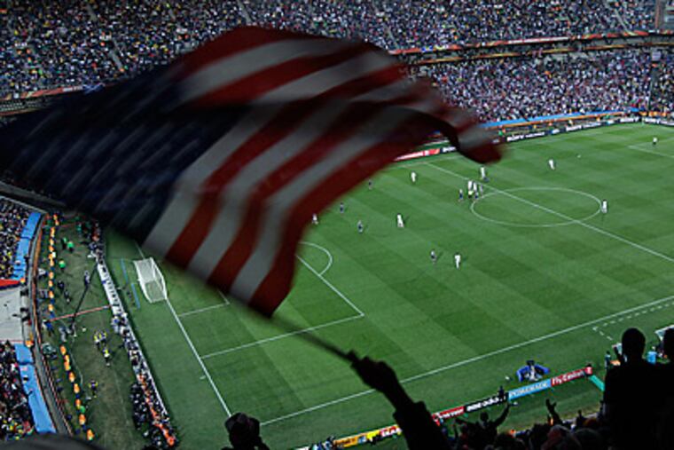 A U.S. fan waves his country's flag after his team scored their first goal against Slovenia. (AP Photo/Hussein Malla)