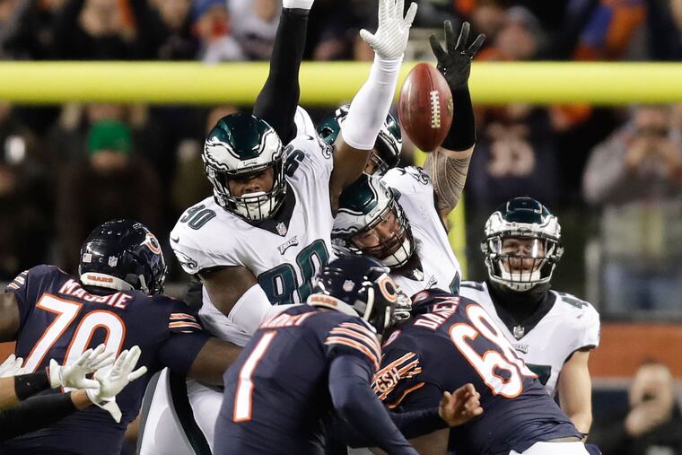 Eagles defensive tackle Treyvon Hester and Eagles defensive tackle Haloti Ngata leap after the football on Chicago Bears kicker Cody Parkey game winning field goal late in the fourth-quarter in NFC Wildcard playoff game on Sunday, January 6, 2019 in Chicago. Parkey missed and the Eagles won 16-15.