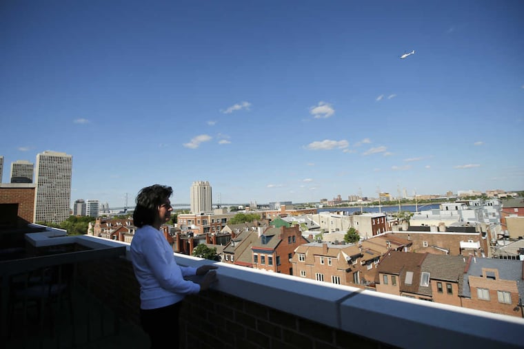 Carol Klein stands outside her Abbotts Square condominium. Residents are angry about construction issues in the building and have filed a lawsuit against developer Eric Blumenfeld