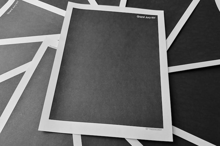 Pages from a totally redacted New York grand jury file on the investigation into Jeffrey Epstein and Ghislaine Maxwell, released by the U.S. Justice Department, is photographed Friday, Dec. 19, 2025, in Washington.