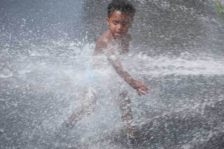 Two-year-old Camren Amtos plays in a fire hydrant along 4th Street in Feltonville with his stepfather (not pictured) on July 2, 2014. (RON TARVER / Staff Photographer)