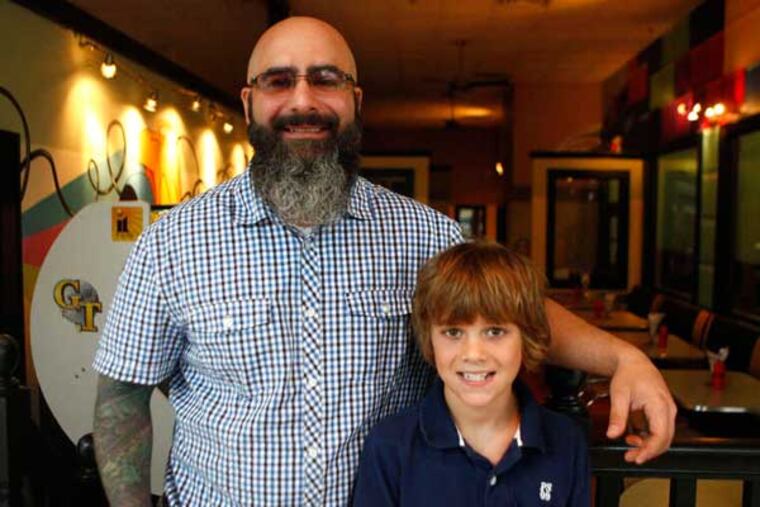 Alex Capasso and his son, Benny, in Benny's Burger Joint, in the former Woolworth's in Collingswood. The restaurant is decorated with 1980s-theme, cartoon-style murals.