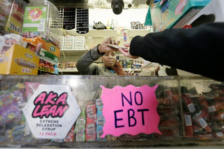 At Nelvin Grocery, Lizbeth Vazquez returns cell phones to Kensington High students who have stored their cell phones for the day at store.