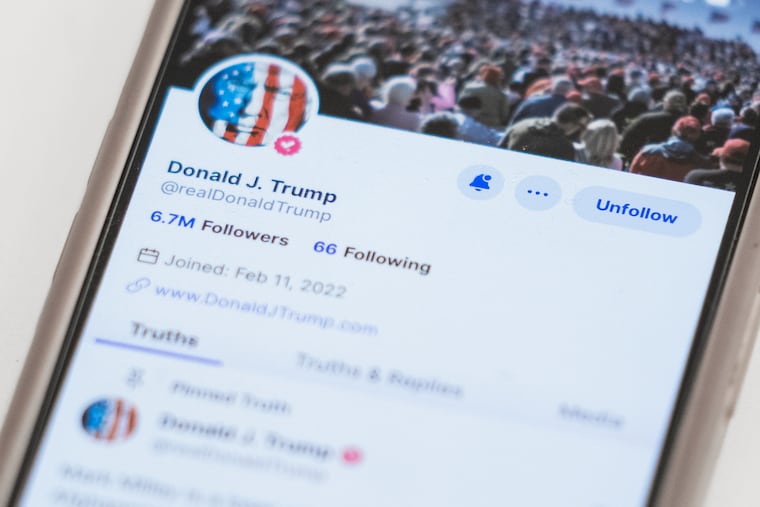 The Truth Social account for former President Donald Trump is seen on a mobile device. On Monday, less than a week after a flashy stock market debut, Trump's social media company disclosed that it lost nearly $58.2 million in 2023.