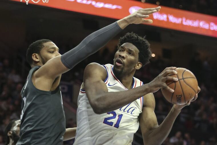 Sixers' Joel Embiid goes up for a shot with Nets' Jahlil Okafor during the 3rd quarter at the Wells Fargo Center in Philadelphia, Friday, March 16, 2018. Sixers beat the Nets 120-116.