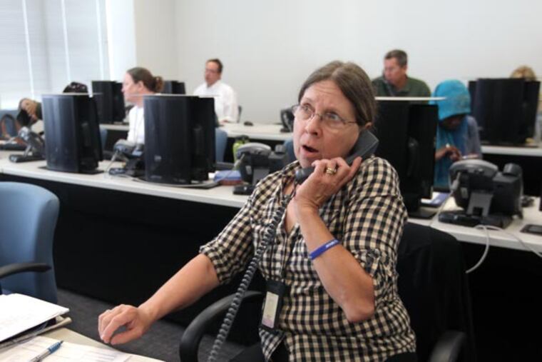 Terry Miller, a Philadelphia School District staffer, takes a call about a transportation problem at a district school. At the Philadelphia School District Headquarters we monitor the school district's special school-opening command center and observe as a dozen district staffers field phone calls and e-mails from principals reporting problems and asking questions on what is shaping up to be a first day of school like no other. ( MICHAEL BRYANT / Staff Photographer )