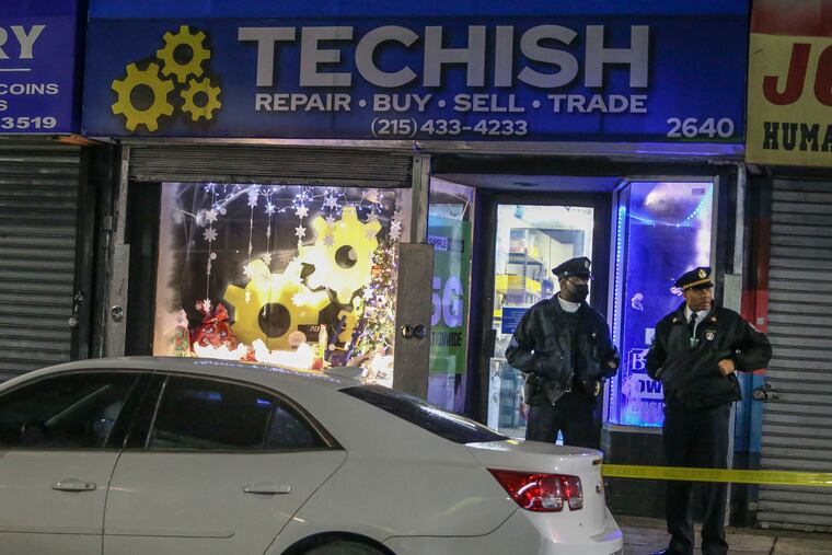 Police at the scene of a phone store on the 2600 block of Germantown Avenue where a man was fatally shot on Tuesday.