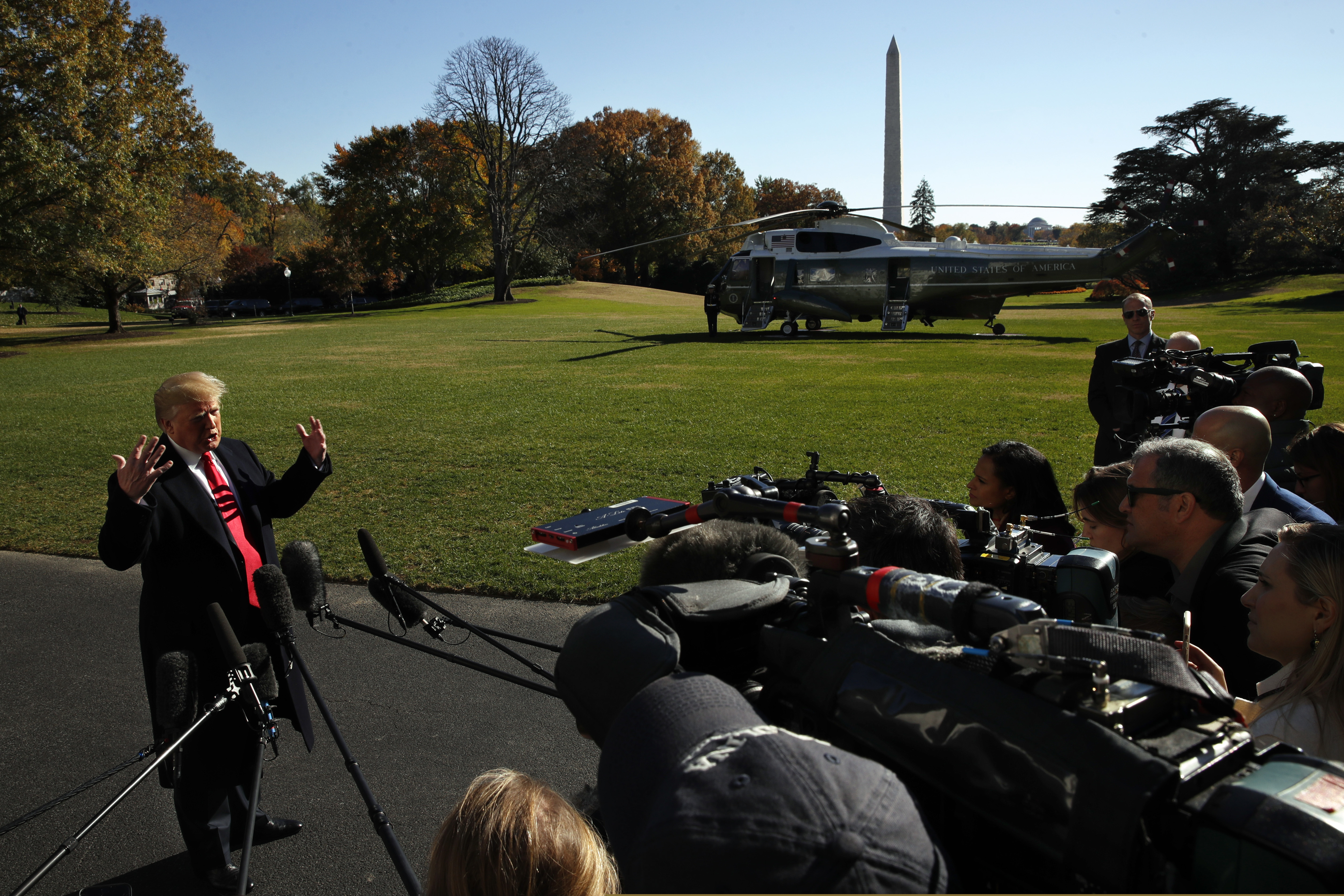 President Donald Trump answers questions from members of the media as he leaves the White House in 2018. His attacks on the media have hurt press freedom.