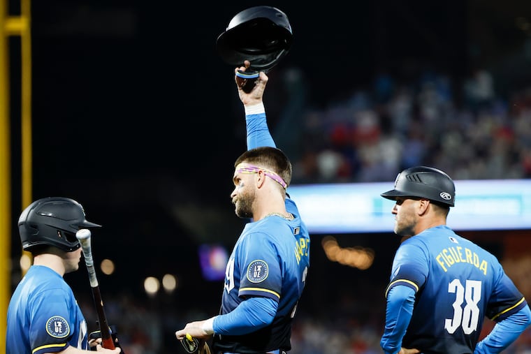 Phillies Bryce Harper raises his batting helmet after hitting a fifth inning RBI single against the Pittsburgh Pirates on Friday, May 16, 2025 in Philadelphia. The single was Harper’s 1000th career RBI.