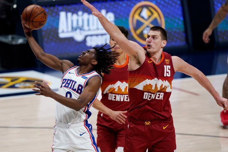 Sixers guard Tyrese Maxey drives to the rim as Denver Nuggets center Nikola Jokic (15) and forward Michael Porter Jr. defend in the second half.