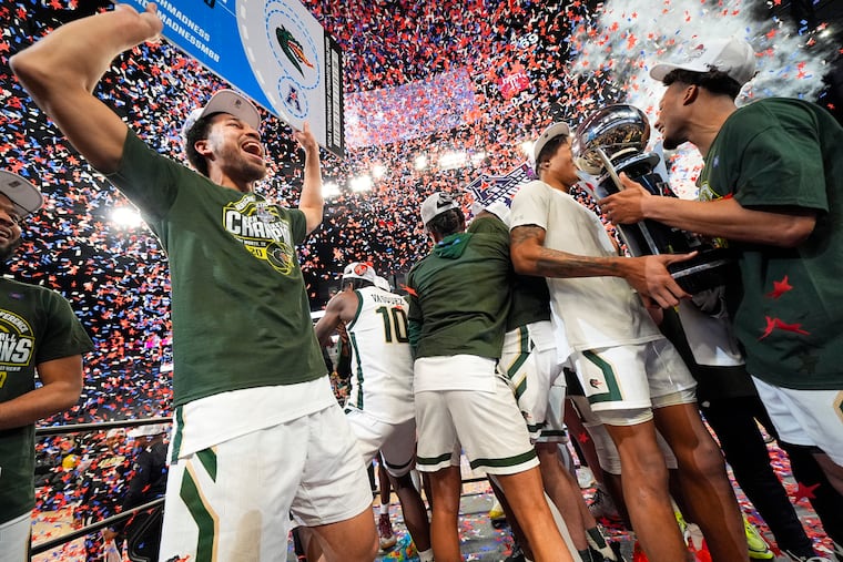 Alabama-Birmingham's Seth Sigmon, left, reacts as teammates celebrate after defeating Temple in the championship of the American Athletic Conference tournament on Sunday in Fort Worth, Texas. UAB won 85-69.