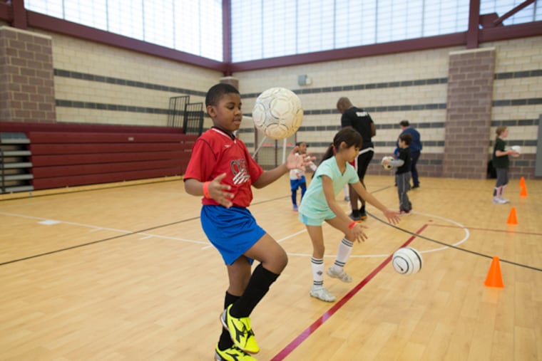 Israel Myers, 8, of Camden, practices soccer drills, Jan. 31, 2015, at Camden's new Kroc Center. (DAVID SWANSON / Staff Photographer)