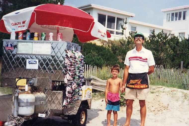 LouDogs founder Lou Subashi stands on the beach at Sea Isle City with his hot dog cart and his son, Christian, then 5.