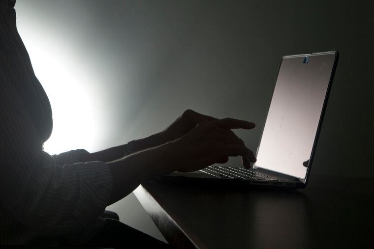 FILE - In this Dec. 12, 2016, file photo illustration, a person types on a laptop in Florida. Riviera Beach, Fla., agreed to pay $600,000 in ransom to hackers who took over its computer system, the latest in thousands of attacks worldwide aimed at extorting money from governments and businesses. Spokeswoman Rose Anne Brown said Wednesday, June 19, 2019, that the city of 35,000 residents has been working with outside security consultants, who recommended the ransom be paid. (AP Photo/Wilfredo Lee, File)
