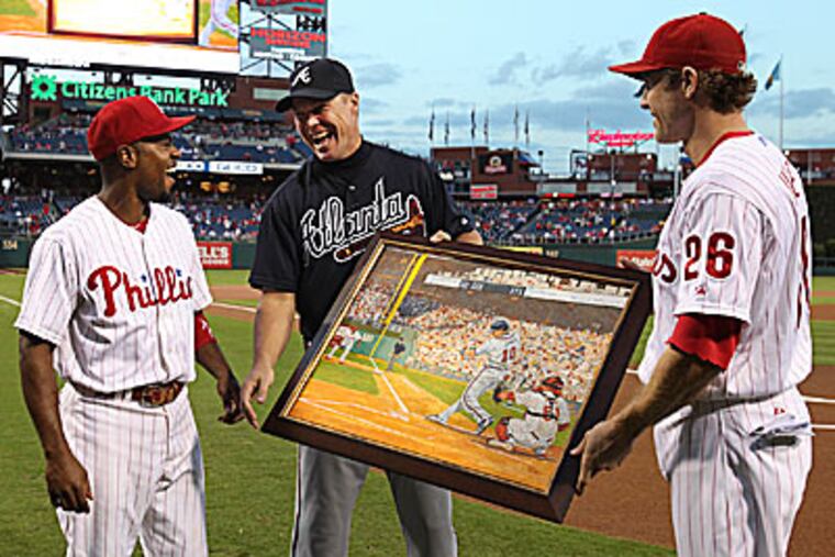Jimmy Rollins and Chase Utley present a painting to Chipper Jones on behalf of the Phillies organization. (Steven M. Falk/Staff Photographer)