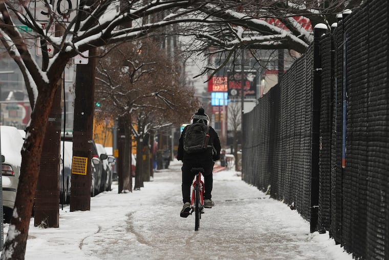 A cyclist passes Chew Park in the Point Breeze section of Philadelphia on Tuesday.