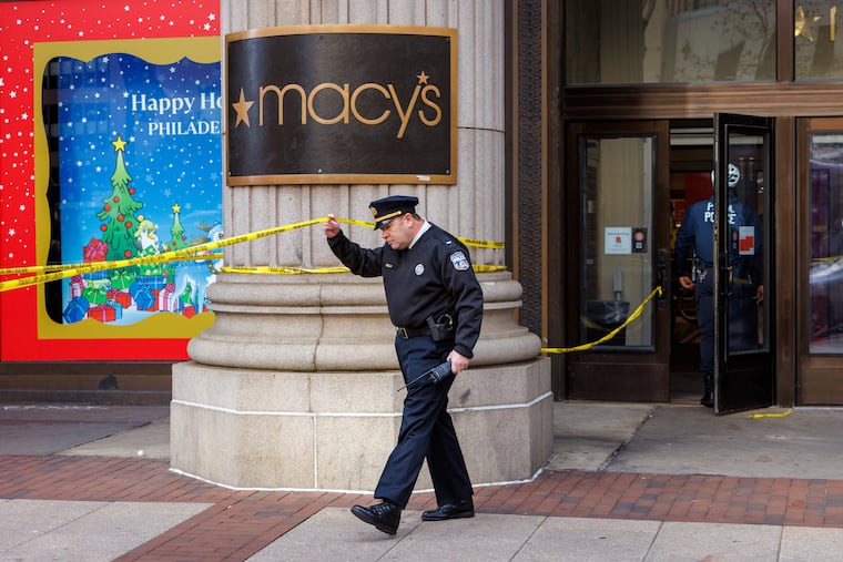 Philadelphia police investigate a fatal stabbing at the Macy’s department store at 13th and Market Streets in Center City on Monday.