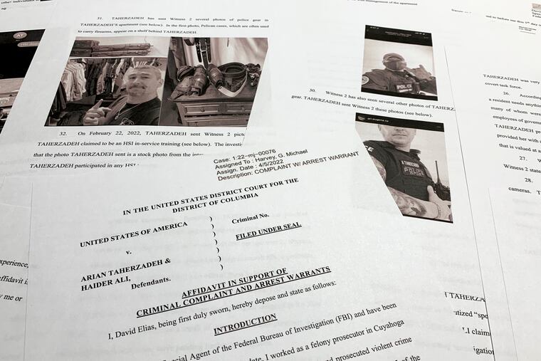 The affidavit to support the arrest of Arian Taherzadeh and Haider Ali is photographed Wednesday, April 6, 2022. Federal prosecutors have charged the two men they say were posing as federal agents, giving free apartments and other gifts to U.S. Secret Service agents, including one who worked on the first lady's security detail. Both were taken into custody as more than a dozen FBI agents charged into a luxury apartment building in Southeast Washington on Wednesday evening.