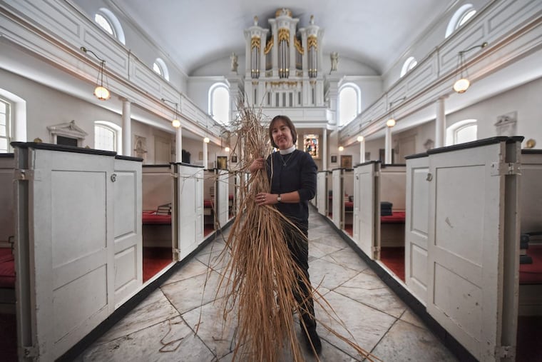 Rev. Claire Nevin-Field holds the ornamental grass that members of St. Peter’s Episcopal Church in Society Hill will wave on Palm Sunday.