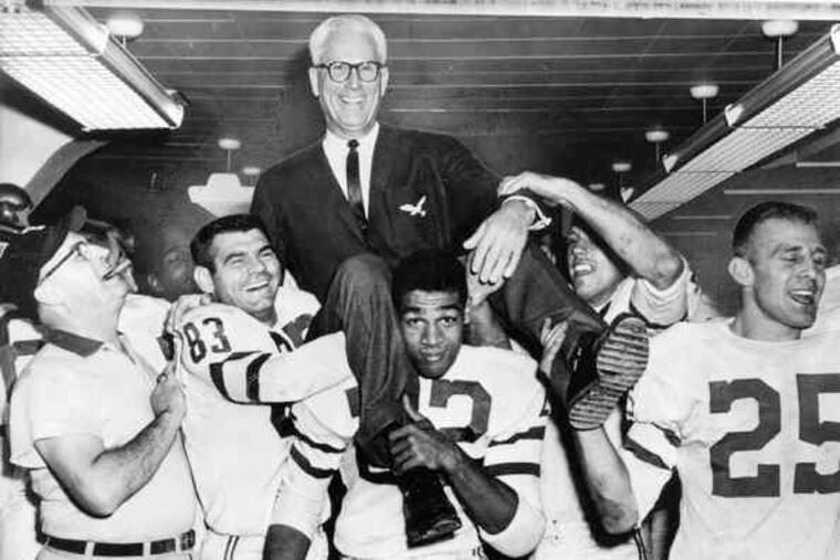 Coach Buck Shaw gets a lift from Bobby Walston (83), Tim Brown (22) and Tommy McDonald (25) after the Eagles clinched a spot in the 1960 championship game. Walston and McDonald were the team's leading scorers.
