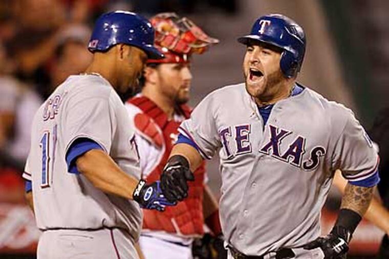 Mike Napoli (right) and the Texas Rangers will play the Rays in the ALDS. (Chris Carlson/AP)