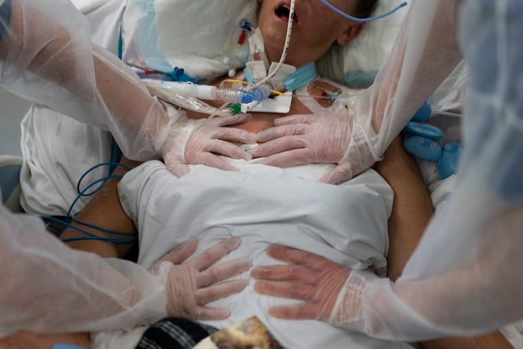 Nurses performing timed breathing exercises on a patient on a ventilator in the COVID-19 intensive care unit at the la Timone hospital in Marseille, France, on Dec. 31, 2021.