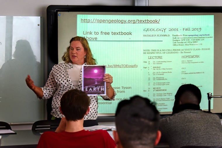 Temple University physical geology professor Natalie Flynn talks to her students about using a free website (on smart board) instead of a textbook, on the first day of class Aug. 26, 2019. She is using open resource materials in the classroom as part of a program at Temple that encourages professors to write their own textbooks or use other free resources so students don't have to buy expensive textbooks.