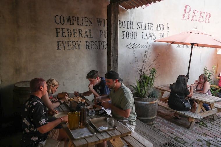 People dine outside at Fette Sau in Fishtown.