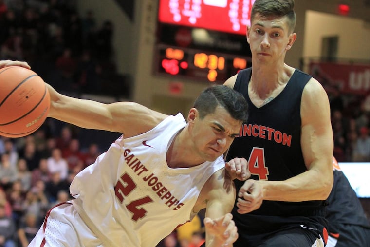 Pierfrancesco Oliva, left, of St. Joseph’s drives against Mike LeBlanc of Princeton in the 2nd half on Nov. 18, 2017. CHARLES FOX / Staff Photographer