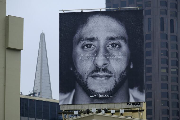 A large billboard stands on top of a Nike store showing former San Francisco 49ers quarterback Colin Kaepernick at Union Square, Wednesday, Sept. 5, 2018, in San Francisco.