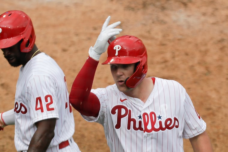 Phillies Rhys Hoskins celebrates his fifth inning three run home run with teammate Andrew McCutchen against the Atlanta Braves on Saturday, August 29, 2020 in Philadelphia.
