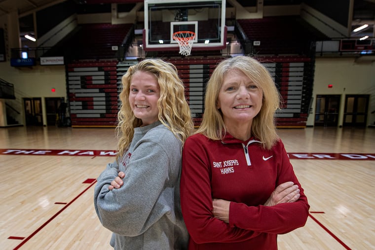 St. Joseph's women's basketball coach Cindy Griffin (right) poses for a photo with her daughter, Kaylie, at Hagan Arena.