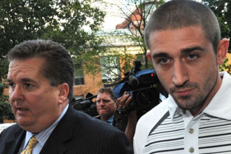 Kenneth W. Smith, Jr. (right), 26, facing federal charges for making false threats that led to a US Airways flight turning around and a passenger being searched and detained, is led into the Federal Courthouse by his lawyer William J. Brennan on Friday, Sept. 7, 2012. ( CLEM MURRAY / Staff Photographer )