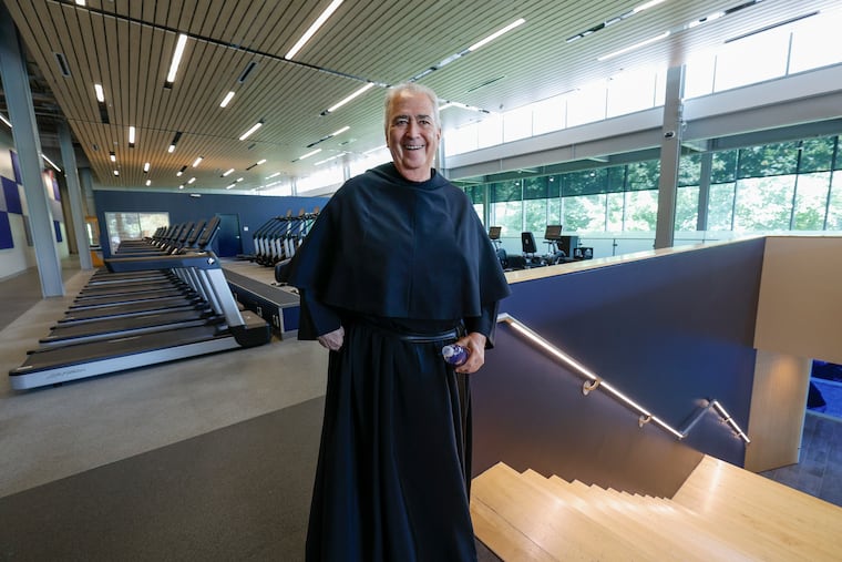 Villanova President the Rev. Peter M. Donohue talks about the exercise equipment available in the Dixon Center, which the school will use as a secondary recreational facility.