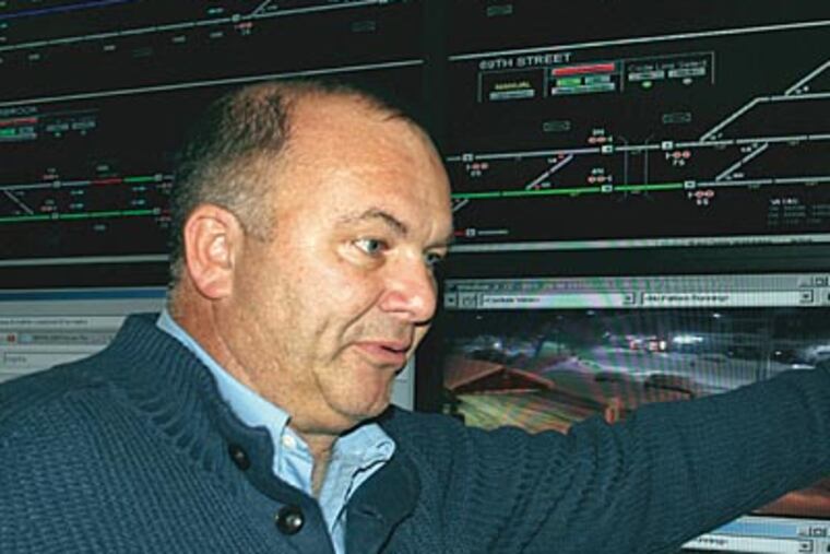 SEPTA’s Ron Hopkins points to a map of Norristown High Speed Line, where a fallen tree stranded riders for more than an hour. (JIMMY VIOLA / Staff photographer)