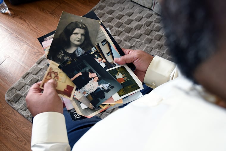 Derrick Johnson, whose mother's body was one of 189 left to decay in the Return to Nature Funeral Home in Penrose, Colo., show photos of her.