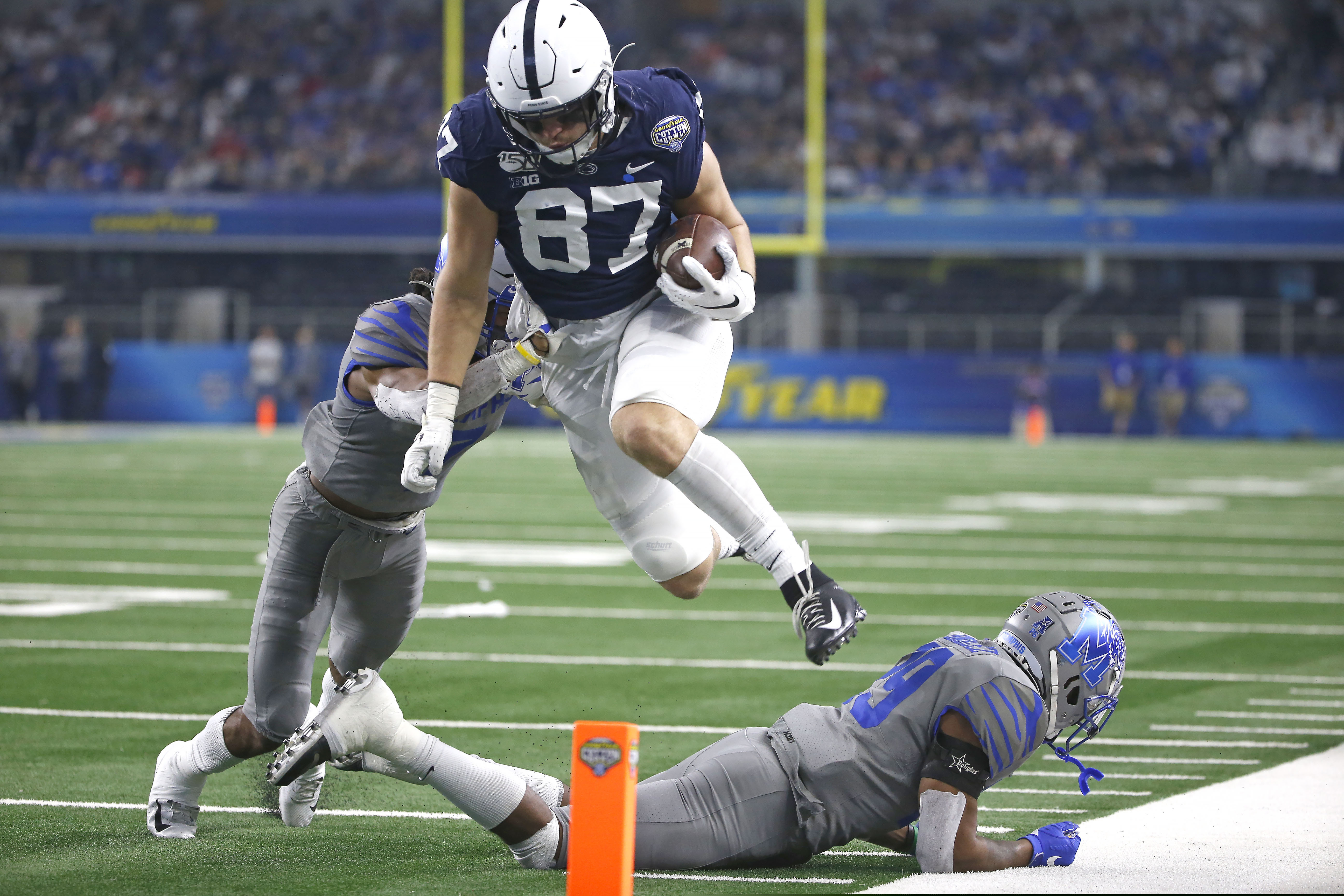 Penn State tight end Pat Freiermuth, here leaping over two Memphis defensive backs in last December's Cotton Bowl, says he is confident that the Nittany Lions will continue to make sacrifices to stay safe in their hopes of playing a full 2020 season.