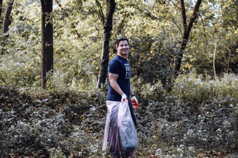 Brian Linton, seen here cleaning up Bartram's Garden, is ready to debut what he calls the "Ultimate American Sock."