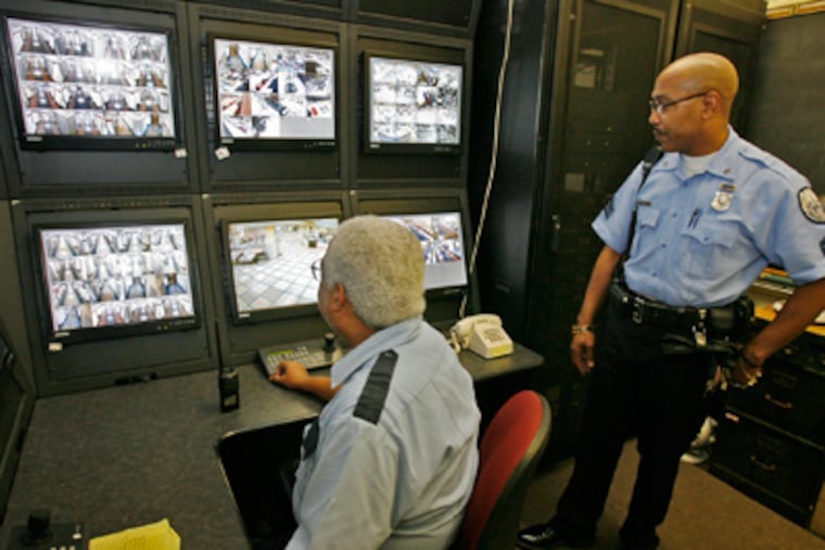 Security officers Carl Curtis (left) and Robert Samuels monitor the newly installed cameras at South Philadelphia High School. (Alejandro A. Alvarez / Staff Photographer)